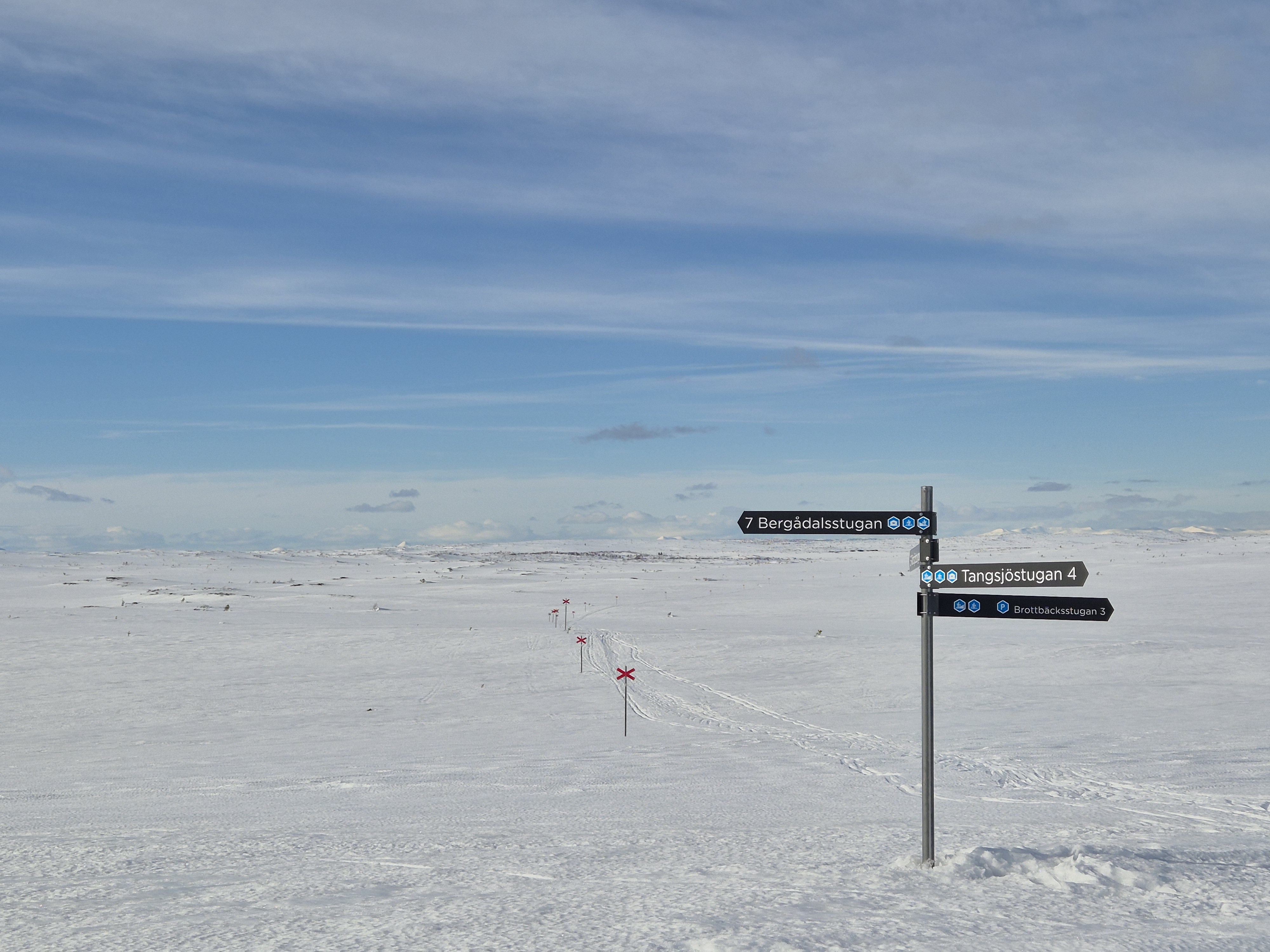 Snowy mountain landscape with trail signs
